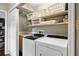 Functional laundry room with modern washer and dryer, shelving, and ample storage space at 2574 Sugarplum Ne Ct, Atlanta, GA 30345