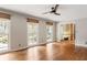 Sunlit living room featuring gleaming hardwood floors and large windows with views of the surrounding greenery at 2574 Sugarplum Ne Ct, Atlanta, GA 30345