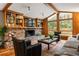 Inviting living room with a brick fireplace, built-in shelving, and large windows at 2574 Sugarplum Ne Ct, Atlanta, GA 30345