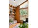 Living room nook featuring a brick fireplace, built-in shelving, and sun-filled window at 2574 Sugarplum Ne Ct, Atlanta, GA 30345