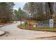 Roadway leading to Henderson Park's East Entrance, framed by lush trees and park signage at 2574 Sugarplum Ne Ct, Atlanta, GA 30345