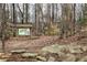 Park map kiosk providing visitors with directional information amidst a wooded landscape at 2574 Sugarplum Ne Ct, Atlanta, GA 30345