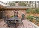 Brick patio features an outdoor dining area, grill, and landscaped surroundings at 2574 Sugarplum Ne Ct, Atlanta, GA 30345