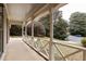 The expansive porch features classic white railing, offering serene views of the surrounding lush greenery and street at 2574 Sugarplum Ne Ct, Atlanta, GA 30345