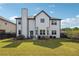 Spacious backyard with lush green grass, a black fence and a white siding house at 4205 Idlewood Dr, Cumming, GA 30040