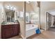 Bathroom featuring double sinks, a soaking tub, and tiled floors at 4205 Idlewood Dr, Cumming, GA 30040