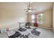 Neutral bedroom features a ceiling fan, large windows and a stylish area rug at 4205 Idlewood Dr, Cumming, GA 30040