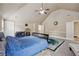 Bedroom features a blue bedspread, vaulted ceilings, carpet, and a decorative rug at 4205 Idlewood Dr, Cumming, GA 30040