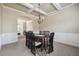 Elegant dining room with coffered ceilings, chandelier, wainscoting, and view to the living room at 4205 Idlewood Dr, Cumming, GA 30040