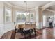 Dining room featuring wainscoting detail, a view of the backyard, and a modern chandelier at 4205 Idlewood Dr, Cumming, GA 30040