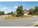 Landscaped corner lot home featuring a two-car garage, mature trees, and a well-maintained lawn at 4205 Idlewood Dr, Cumming, GA 30040