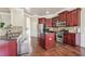 Kitchen with granite countertops, stainless steel appliances, an island, and wood floors at 4205 Idlewood Dr, Cumming, GA 30040