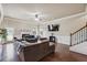 Spacious living room featuring hardwood floors, a fireplace, and a staircase with wooden railings at 4205 Idlewood Dr, Cumming, GA 30040