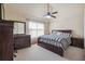 Comfortable main bedroom with a ceiling fan, carpeted floor and a large dresser with mirror at 4205 Idlewood Dr, Cumming, GA 30040