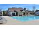 Outdoor community pool with a clubhouse, lounge chairs, and seating area at 4205 Idlewood Dr, Cumming, GA 30040