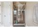 Tiled shower with sliding glass doors and shampoo caddy at 4205 Idlewood Dr, Cumming, GA 30040