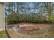 Landscaped backyard area with a circular patio and garden beds at 6645 Doublegate Ln, Rex, GA 30273
