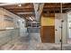 Unfinished basement with concrete foundation and wood paneled walls provides ample storage space at 6645 Doublegate Ln, Rex, GA 30273