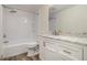 Bathroom featuring a shower-tub combo and modern vanity with a marble countertop at 6645 Doublegate Ln, Rex, GA 30273