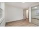 Bedroom with vinyl floors, a window, and large mirrored closet doors at 6645 Doublegate Ln, Rex, GA 30273