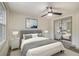 Comfortable bedroom features a ceiling fan, closet with mirrors, and a neutral color palette at 6645 Doublegate Ln, Rex, GA 30273