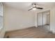 Bright bedroom featuring a ceiling fan, and mirrored closet doors at 6645 Doublegate Ln, Rex, GA 30273