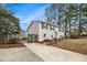 Inviting home featuring a spacious driveway, wooden fence, and mature trees at 6645 Doublegate Ln, Rex, GA 30273