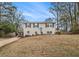 Traditional two-story home with a well-kept lawn, inviting front entrance, and lots of natural light at 6645 Doublegate Ln, Rex, GA 30273