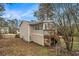 Back exterior of home features screened porch with deck overlooking fenced yard at 6645 Doublegate Ln, Rex, GA 30273
