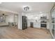 Modern kitchen featuring stainless steel appliances, white cabinets, and stylish light fixtures at 6645 Doublegate Ln, Rex, GA 30273