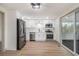 Updated kitchen featuring stainless steel appliances, sleek white cabinets, and abundant natural light at 6645 Doublegate Ln, Rex, GA 30273