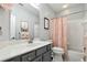 Bright bathroom features a shower-tub combo with a tile surround and modern sink at 6775 Marlow Dr, Cumming, GA 30041
