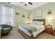 Charming bedroom with a queen-sized bed, neutral tones, and a large window at 6775 Marlow Dr, Cumming, GA 30041