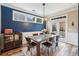 Elegant dining room with wood flooring, modern light fixture, and access to the patio at 6775 Marlow Dr, Cumming, GA 30041
