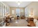 Cozy home office with natural light, desk, chair, neutral walls, shutters, and versatile decor at 6775 Marlow Dr, Cumming, GA 30041