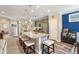 Kitchen with granite island, counter seating, stainless appliances, pendant lighting, and view into dining area at 6775 Marlow Dr, Cumming, GA 30041