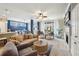 Bright living room with fireplace, custom built-ins, modern furnishings and view to open kitchen and dining area at 6775 Marlow Dr, Cumming, GA 30041