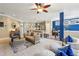 Open-concept living room with bar seating that flows into the kitchen and dining area at 6775 Marlow Dr, Cumming, GA 30041