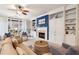 Bright living room with a cozy fireplace, custom built-ins, and natural light at 6775 Marlow Dr, Cumming, GA 30041