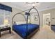 Bedroom featuring canopy bed, plush carpet, neutral walls with wainscoting and ensuite bathroom entrance at 6775 Marlow Dr, Cumming, GA 30041