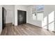 Bedroom with closet, a window overlooking exterior, wood-look floors, and white walls at 1092 Wedgewood Nw Dr, Atlanta, GA 30318
