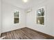 Bedroom with a view to an exterior space featuring two bright windows and wood-look floors at 1092 Wedgewood Nw Dr, Atlanta, GA 30318