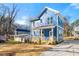 Inviting light blue home with a charming front porch, manicured lawn and an attractive neighborhood view at 1092 Wedgewood Nw Dr, Atlanta, GA 30318