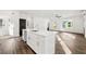 Contemporary kitchen offers stylish island, sleek white cabinets and great flow to the spacious living room at 1092 Wedgewood Nw Dr, Atlanta, GA 30318