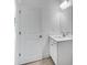 Bright bathroom with a single sink vanity and modern fixtures at 1466 Auburn Glen Rd, Dacula, GA 30019