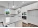 Bright kitchen featuring white cabinets, stainless steel appliances, large island, and pendant lighting at 1466 Auburn Glen Rd, Dacula, GA 30019