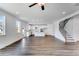 Open-concept living area with white walls, hardwood floors, and seamless connection to kitchen at 1466 Auburn Glen Rd, Dacula, GA 30019