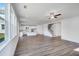 Spacious living area with hardwood floors, a ceiling fan, and open access to kitchen and staircase at 1466 Auburn Glen Rd, Dacula, GA 30019