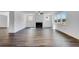 Bright and spacious living room with hardwood floors, fireplace, and large windows offering scenic views at 1466 Auburn Glen Rd, Dacula, GA 30019