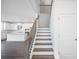 Elegant staircase connects the floors; kitchen and living room are in the background at 1466 Auburn Glen Rd, Dacula, GA 30019